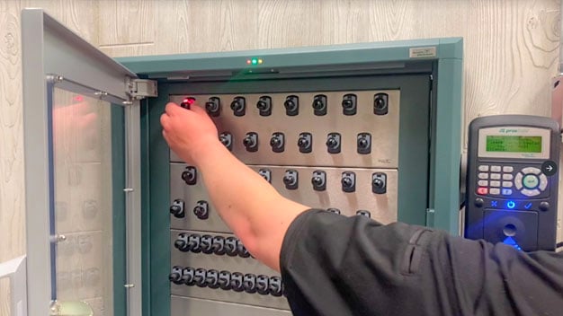 An officer using a smart key management system to manage facilities keys