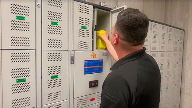 A police officer using a smart locker to store and track evidence