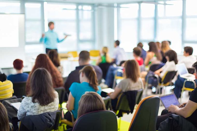 A blurred classroom full of students