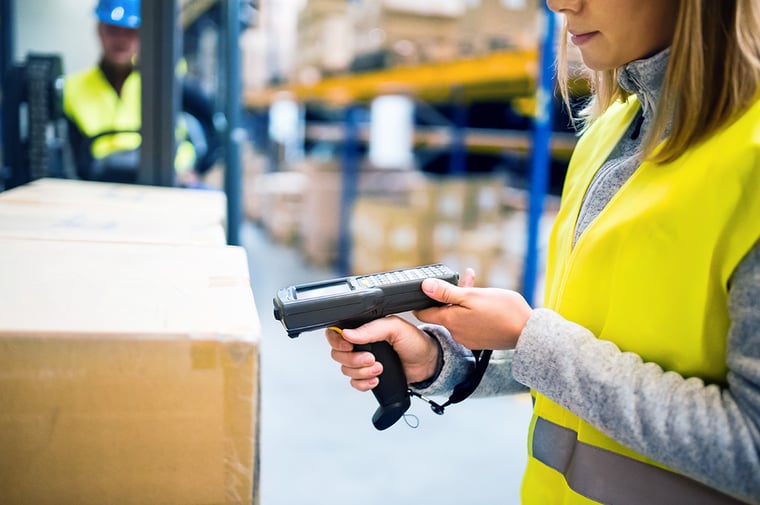 A warehouse employee using a scanner