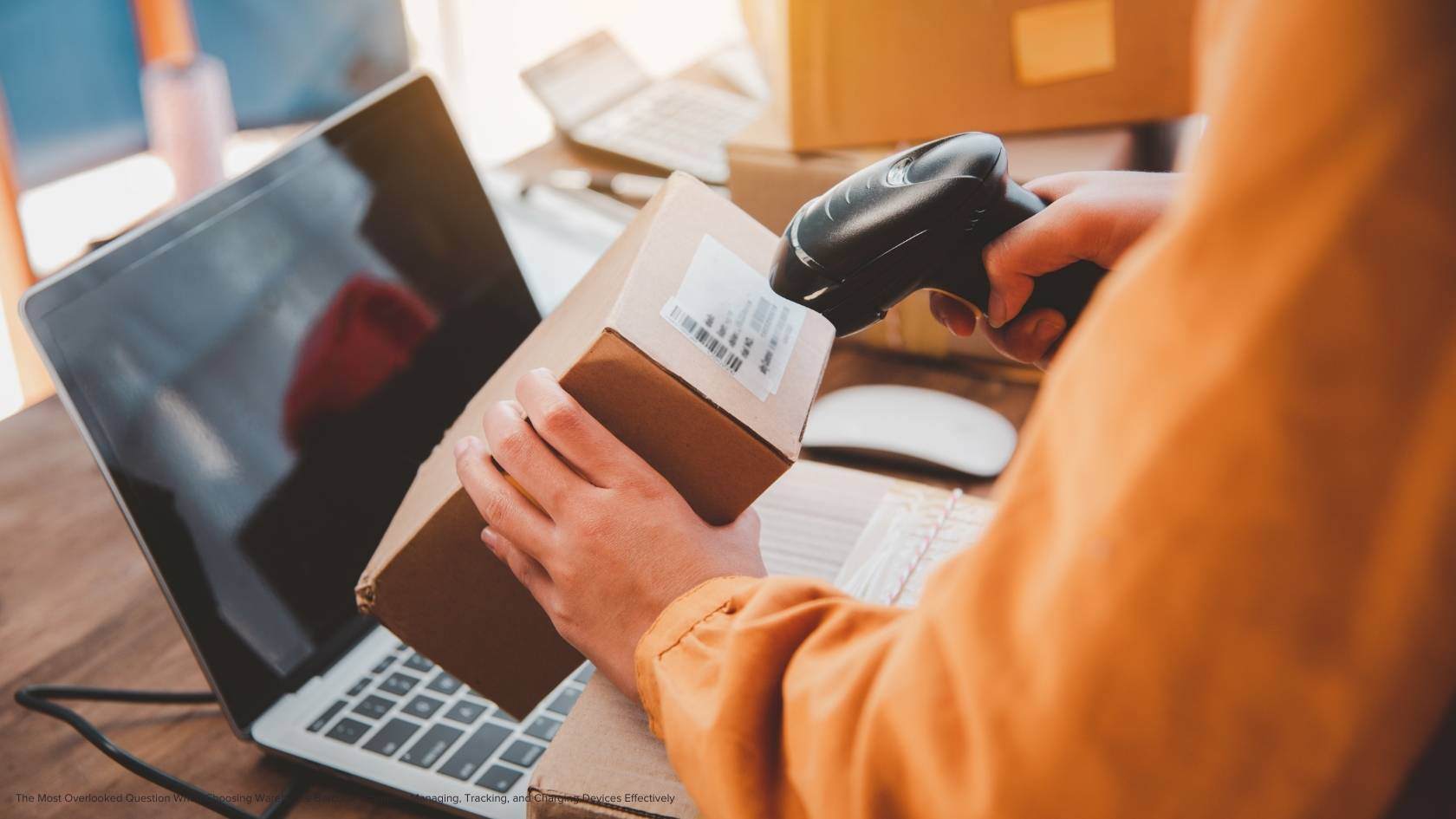 An employee using a hand held scanner to scan a package